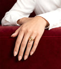 Golden Sculptural Swirl Ring worn on hand