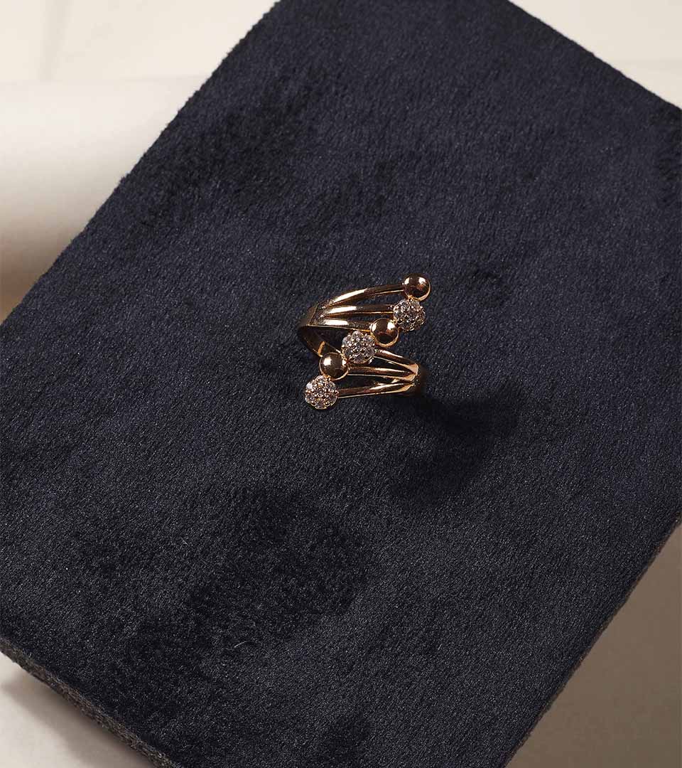 Golden Sculptural Swirl Ring on dark jewellery box