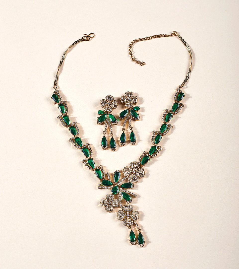 Emerald Green Oval Pendant Necklace Set on display bust with red satin backdrop