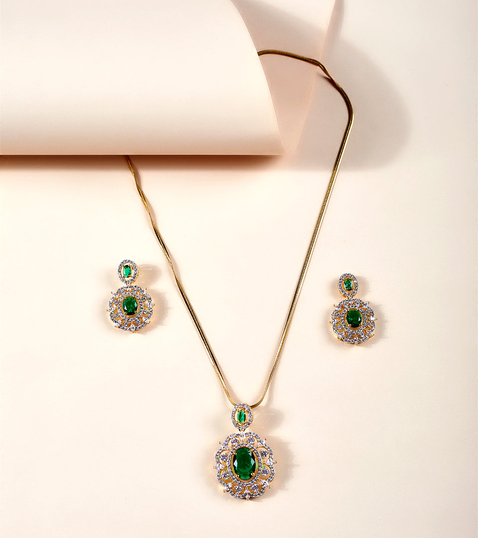 Emerald Green Sunburst CZ Pendant Necklace Set on display bust with red satin backdrop